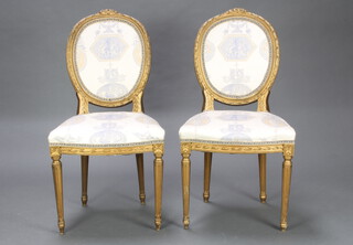 A pair of gilt painted salon chairs with upholstered seats and backs, raised on turned and fluted supports 98cm h x 50cm w x 45cm d (seat 29cm x 27cm) 