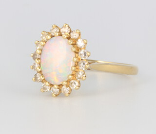 An 18ct yellow gold oval opal and diamond cluster ring, the opal approx. 1.5ct, the diamonds approx 0.16ct, 4.1 grams, size M 