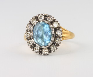 A 15ct yellow gold aquamarine and diamond cluster ring, the centre stone approx. 1.5ct the surrounding diamonds 0.55ct, 3.4 grams, size K 1/2
