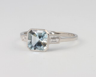 A platinum Art Deco style aquamarine and diamond ring, the centre stone approx. 1.3ct supported by baguette cut diamonds 0.10ct, 2.8 grams, size M