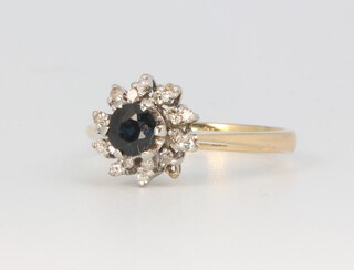 A yellow metal stamped 18, sapphire and diamond cluster ring, 3.3 grams, size L (1 diamond is missing) 
