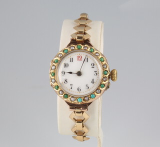 A lady's Edwardian 9ct yellow gold seed pearl and turquoise wristwatch with enamelled dial on a 9ct yellow gold bracelet, contained in a 26mm case