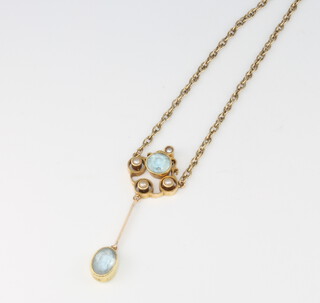 An Edwardian style yellow metal aquamarine and seed pearl pendant 34mm, on a 9ct gold chain, 3.6 grams gross