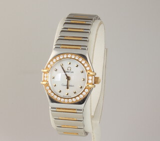 A lady's Omega Constellation My Choice wristwatch with mother of pearl dial and 30 brilliant cut diamond set bezel on a bimetallic bracelet, contained in a 22mm case, the reverse numbered 57643456, with original box, warranty and certificate in a leather pouch 