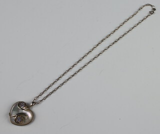 A silver necklace with a silver and mother of pearl heart pendant 18.3 grams and a pierced Scottish brooch 