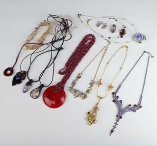 A quantity of vintage and other pendants including hardstone etc 