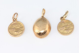 A 9ct yellow gold coffee bean pendant and 2 miniature 9ct yellow gold St Christopher pendants, 4 grams