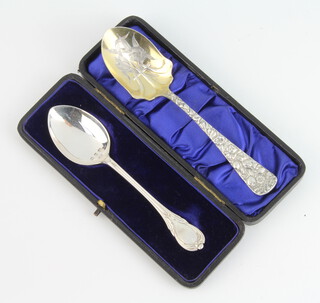 An American cast sterling jam spoon decorated with flowers together with a lily pattern ditto 56 grams