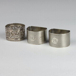 A pair of silver engine turned napkin rings, Birmingham 1933 and 1935, 1 other 82 grams 