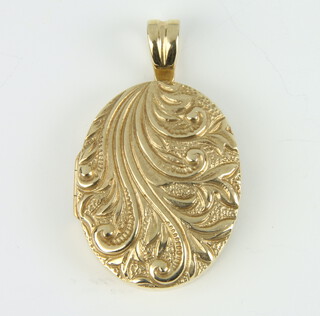 A 9ct yellow gold cast locket with scroll decoration approx. 18 grams 