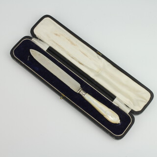 A silver bread knife with carved mother of pearl lily pattern handle, cased 