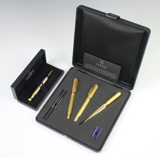 A cased Jakko pen set comprising a gilt fountain pen, a ditto ballpoint pen and a paper knife cased together with a silvered ballpoint pen cased 