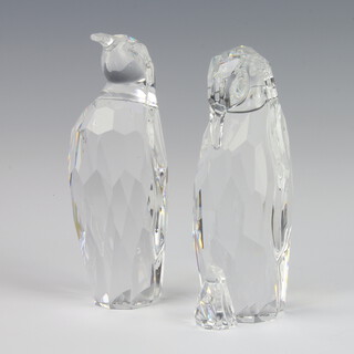 A Swarovski Crystal figure of a penguin with downturned beak 11cm, ditto with an upturned beak 12cm, both boxed
