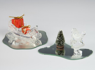 A Swarovski figure of Father Christmas 6cm, ditto sleigh 4cm with mirrored plints, presents and Christmas tree, boxed