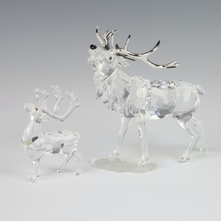 A Swarovski Crystal figure of a reindeer with metal antlers 14cm, a small ditto 8cm, boxed 