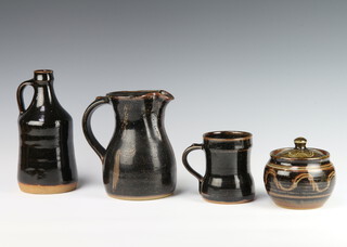 A Winchcombe Studio Pottery preserve pot and cover 10cm, ditto mug 10cm, bottle vase 20cm and baluster jug 28cm