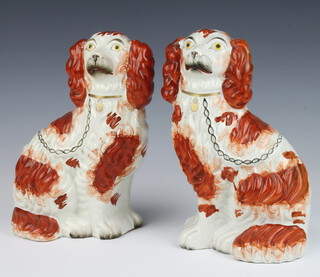 A pair of Victorian Staffordshire Spaniels with black and gilt decoration 23cm (1 cracked) together with a ditto ochre pair 24cm (1 cracked) 