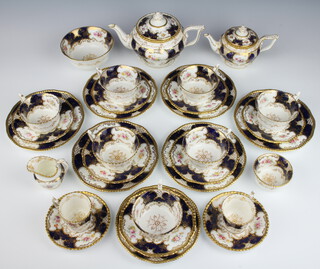 A Coalport tea set with blue and gilt ground and spring floral decoration comprising a large teapot, small teapot, 7 tea cups, 2 coffee cans, sugar bowl, slop bowl, 2 small saucers, 7 large saucers, 7 side plates