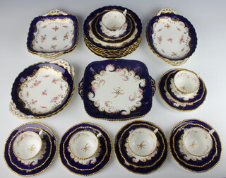 A Coalport part tea set with blue ground decorated flowers comprising 6 tea cups, 6 saucers, 6 small plates, 6 large plates, 4 serving dishes, 2 oval serving dishes and 2 square serving dishes