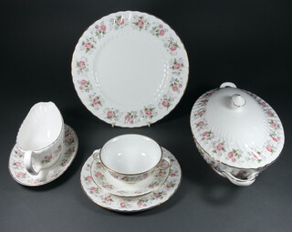 A Minton Spring Bouquet part tea and dinner service comprising six 2 handled cups, 6 saucers, 7 small plates, 7 dinner plates, oval meat plate, 2 oval tureens and covers, sauce boat and stand (stand a/f), salt, pepper and mustard