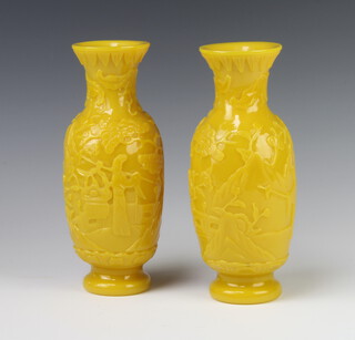 A pair of antique style Chinese yellow glass oviform vases decorated with figures in pavillion gardens 21.5cm 