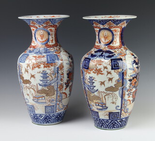 A pair of late 19th Century Chinese Imari vases of oviform pattern with panels of pagodas, exotic birds and flowers with flared necks 37cm 
