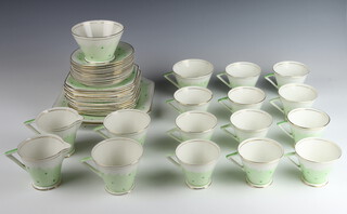 An Art Deco Palissy tea and coffee set comprising 3 tea cups, 11 coffee cups (1 a/f), 11 saucers (2 a/f), 2 milk jugs, sugar bowl (a/f), 12 small plates and 2 serving plates