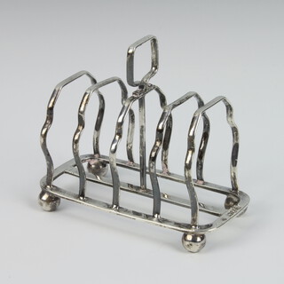 An Edwardian silver 6 bar toast rack raised on ball feet, London 1908, 100 grams, 10cm 