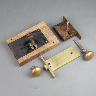 A 19th Century steel and brass lock 20cm x 24cm x 20cm complete with key, a brass lock with key 15cm x 3cm x 8cm, 1 other 15cm x 10cm x 2cm and 2 brass door knobs 

