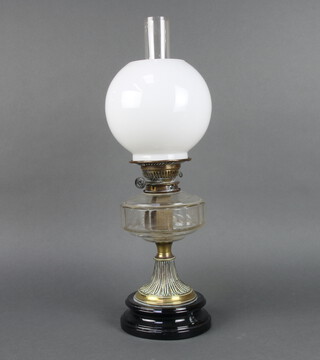 A Victorian clear faceted glass oil lamp, the burner buttons marked Superior Duplex raised on an embossed waisted base with opaque glass shade and clear glass chimney 54cm h x 16cm  