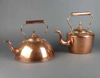 A circular Victorian copper kettle with acorn finial 30cm x 16cm together with a Victorian circular domed copper kettle 26cm x 28cm 