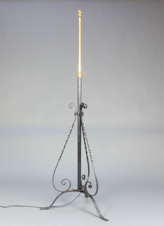 A Victorian wrought iron and brass adjustable standard lamp converted to electricity, on 3 outswept supports 150cm h x 55cm 