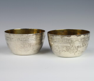 A pair of Georgian style engraved silver bowls with gilt interiors London 1972, 10cm, 466 grams 