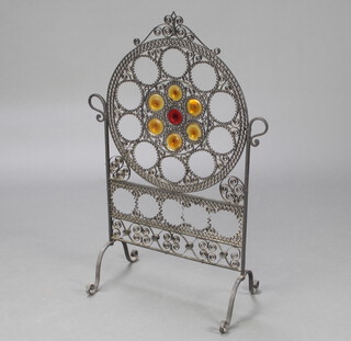 An arched wrought iron and glass fire screen 90cm h x 49cm w x 31cm d 