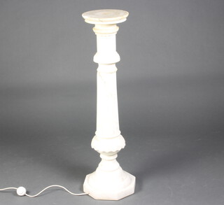 A reeded carved marble column raised on an octagonal base, the interior fitted a light 101cm h  x 24cm 
