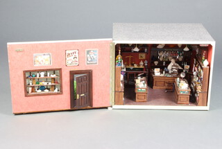 Of Horsham interest, a doll's house in the form of "Carfax Chemist" fitted with various shop fittings and miniature pharmacy bottles etc 36cm h x 48cm w x 45cm 

