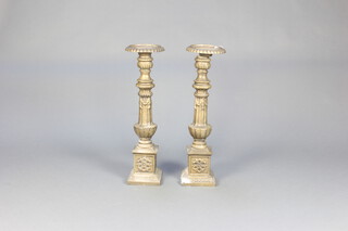 A pair of 17th Century style cast iron pricket candlesticks raised on square bases 70cm x 20cm (1 a/f) 