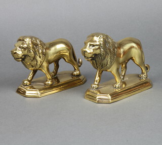 A near pair of polished brass figures of standing lions, raised on shaped bases 13cm x 15cm x 7cm 