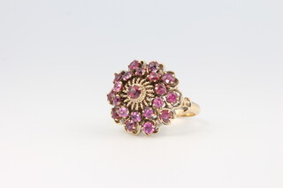 An 18ct yellow gold ruby cluster ring, size N 1/2, 7.3 grams, 