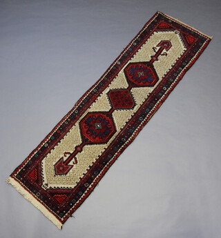 A white and red ground Sarab runner with 3 stylised diamonds to the centre within a multi row border 278cm x 75cm 
