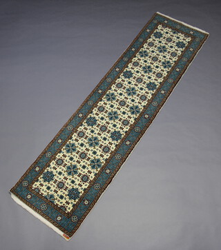 A white and blue ground Viramin runner with medallions to the centre 297cm x 87cm