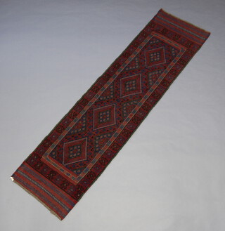 A red and white ground Meshwani runner with 4 octagons to the centre 260cm x 64cm 