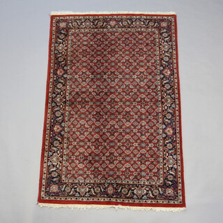 A brown and blue ground Tabriz rug with all over geometric design 181cm x 119cm 