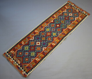 A yellow, turquoise and orange ground Chobi Kilim runner with all-over geometric design 243cm x 79cm 