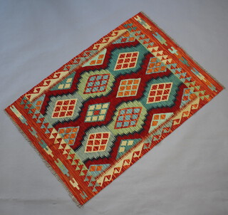 An orange, turquoise and brown ground Chobi Kilim rug with all-over diamond design 150cm x 106cm  
