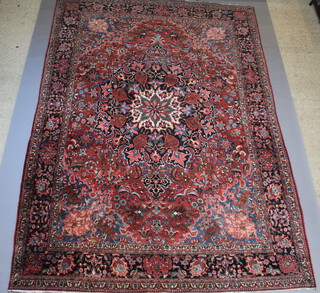 A red, blue and floral ground Northwest Persian carpet with central medallion within a 5 row border 433cm x 303cm 