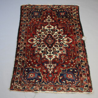 A brown, white and blue ground Persian rug with central medallion 196cm x 135cm 