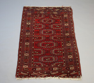 A red and blue ground Bokhara rug with 12 octagons to the centre within a multi row border 175cm x 122cm 