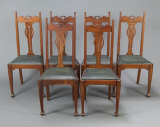 A set of 6 Edwardian Art Nouveau oak slat back dining chairs with upholstered drop in seats, raised on square supports 117cm h x 46cm w x 42cm d (seat 27cm x 30cm)  