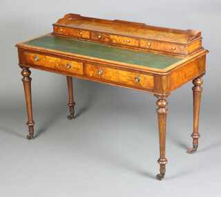 A Victorian figured walnut writing table, the top fitted a super structure with 3/4 gallery and 3 short drawers with inset green writing surface, the base fitted 2 long drawers, raised on turned supports 83cm h x 121cm w x 54cm d